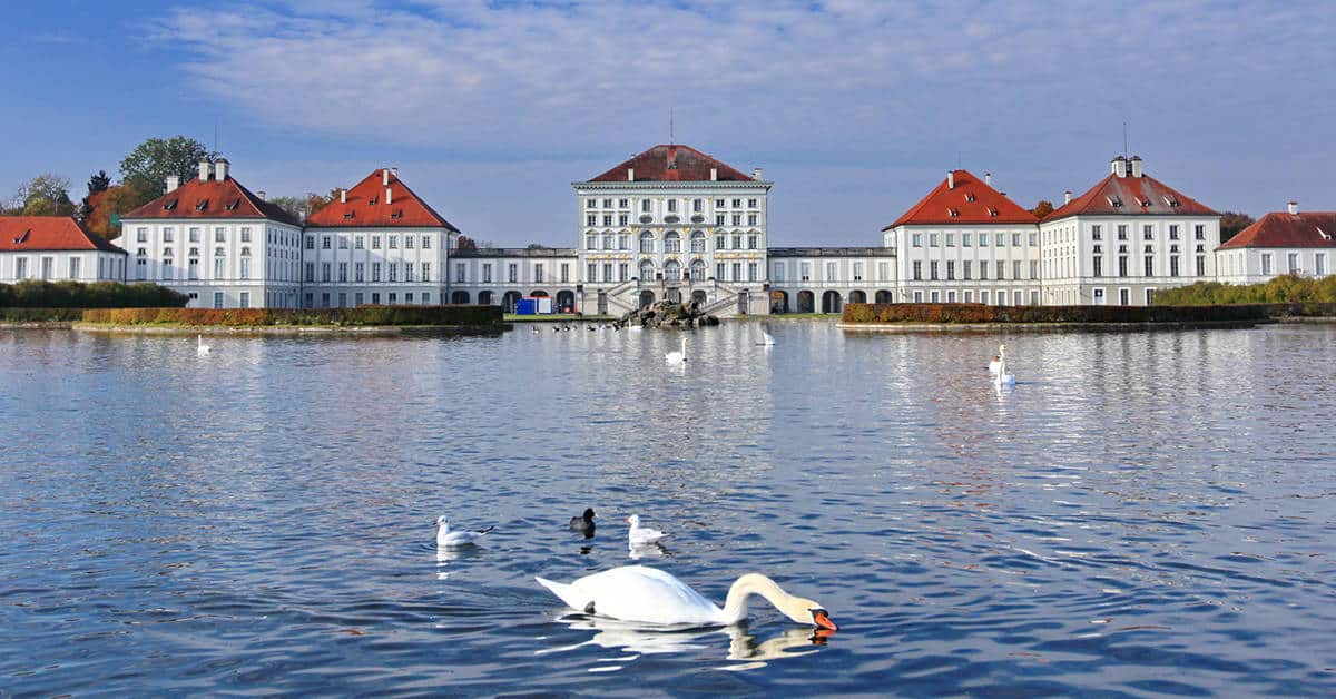 Swans glide through the lakes on the grounds of Nymphenburg Palace. Image credit: Jirobkk/iStock