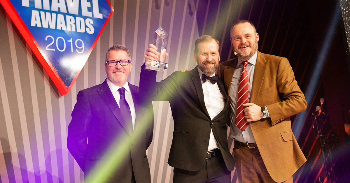 Blacklane's Director of Marketing Norbert Meinike (center) accepting the award at the ceremony, hosted by comedian Al Murray (right). Image credit: BTA 2019
