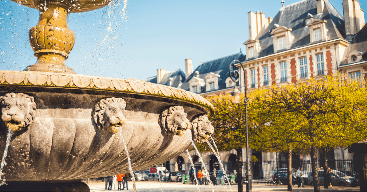 A fountain on the Place des Vosges in the Marais district. Image credit: instamatics/iStock
