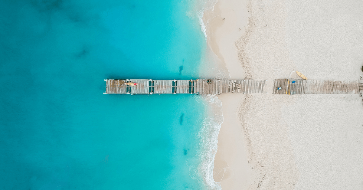 An aerial view of a pier in Grace Bay, Providencials, Turks and Caicos. Image credit: JoaoBarcelos/iStock