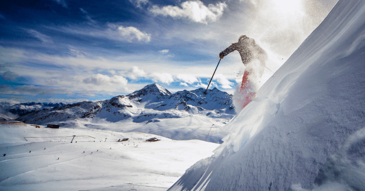A person skis down an ski slope. Image credit: iStock