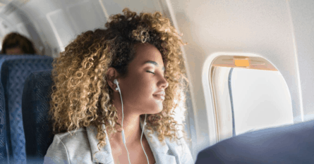 The window seat and having noise-canceling headphones can help you get to sleep. Image credit: SDI Productions/iStock