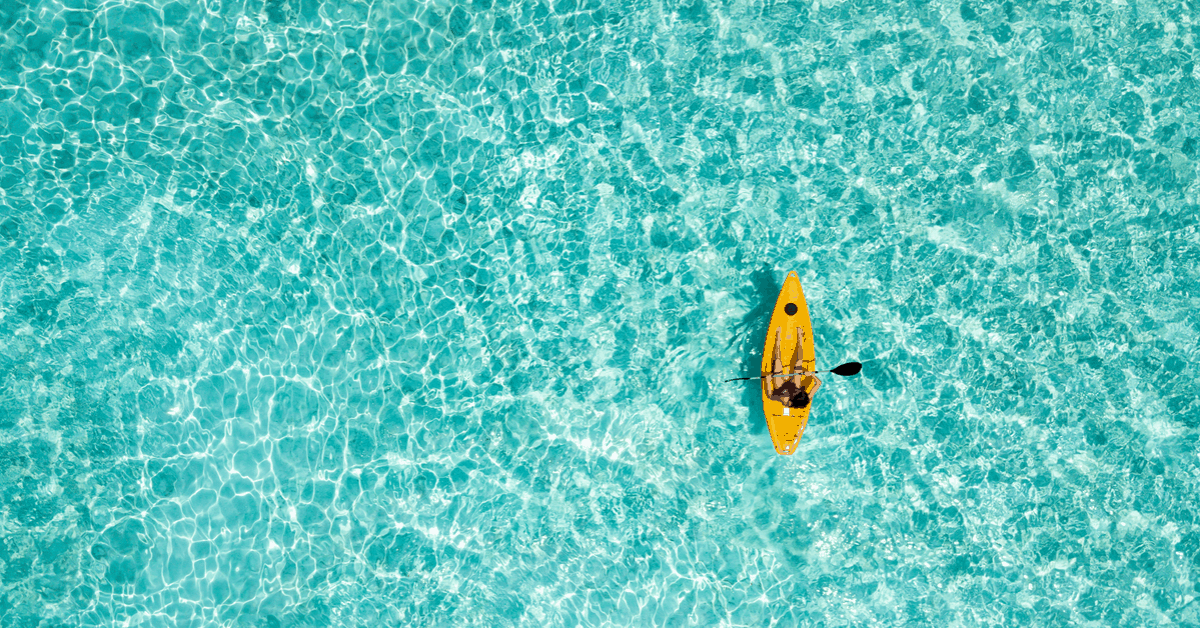 Glide over crystal clear waters in a kayak. Image credit: SHansche/iStock