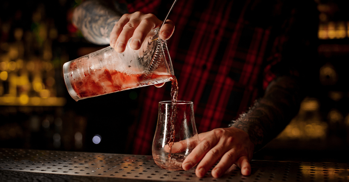 A bartender pours a red sazerac. Image credit: MaximFesenko/iStock