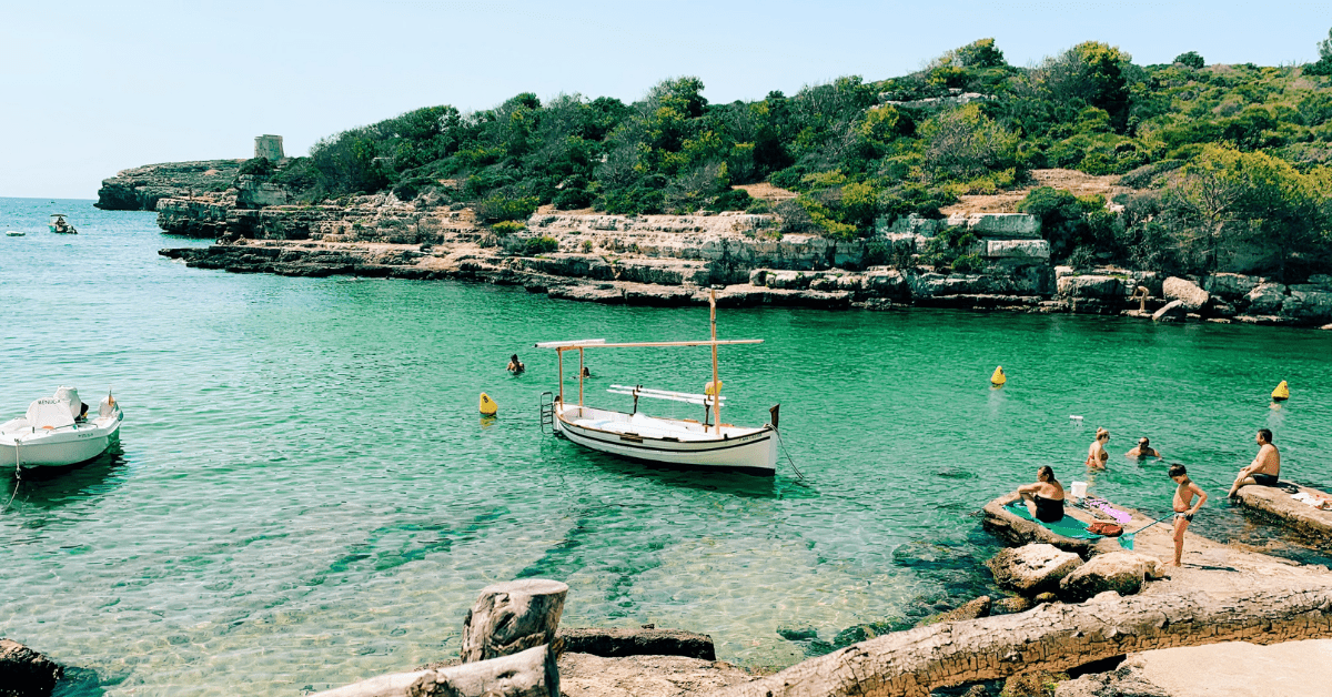 Crystal-clear waters at Cala Alcaufar make this sustainable travel spot a must-visit. Image credit: Laura Velasco/Unsplash