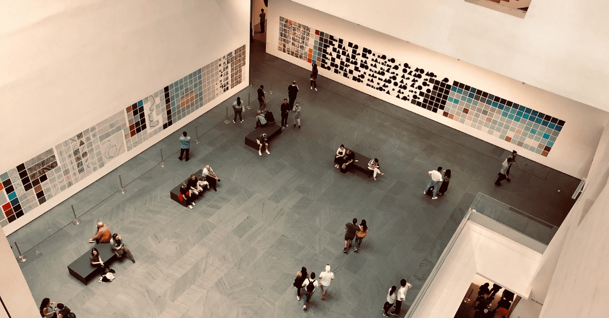 Visitors to the Metropolitan Museum of Art walking around, sitting, and viewing art.