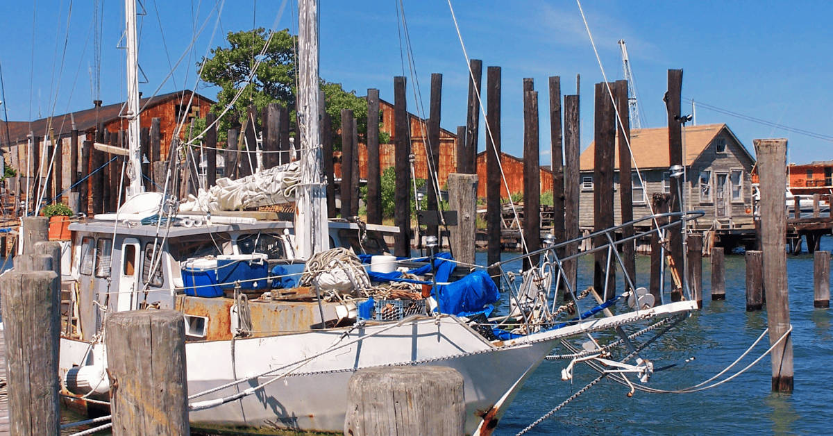 a sailboat docked at a dock in the water.