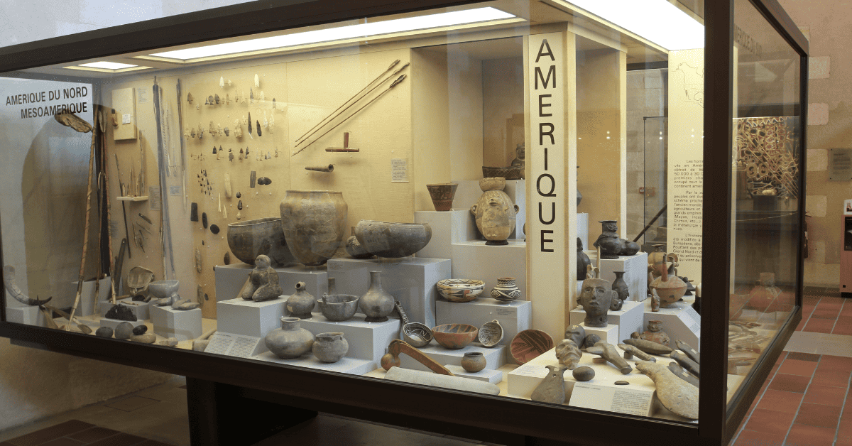 a display case filled with lots of pottery.