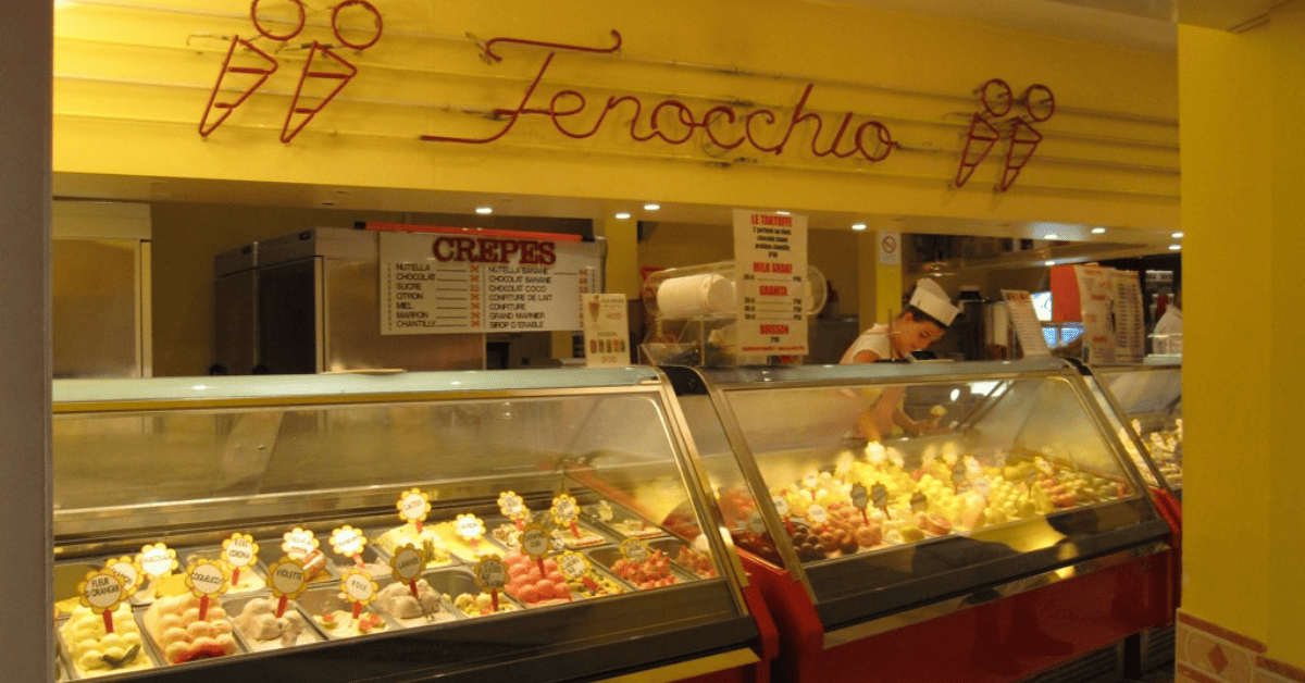 an ice cream shop filled with lots of different types of ice cream.