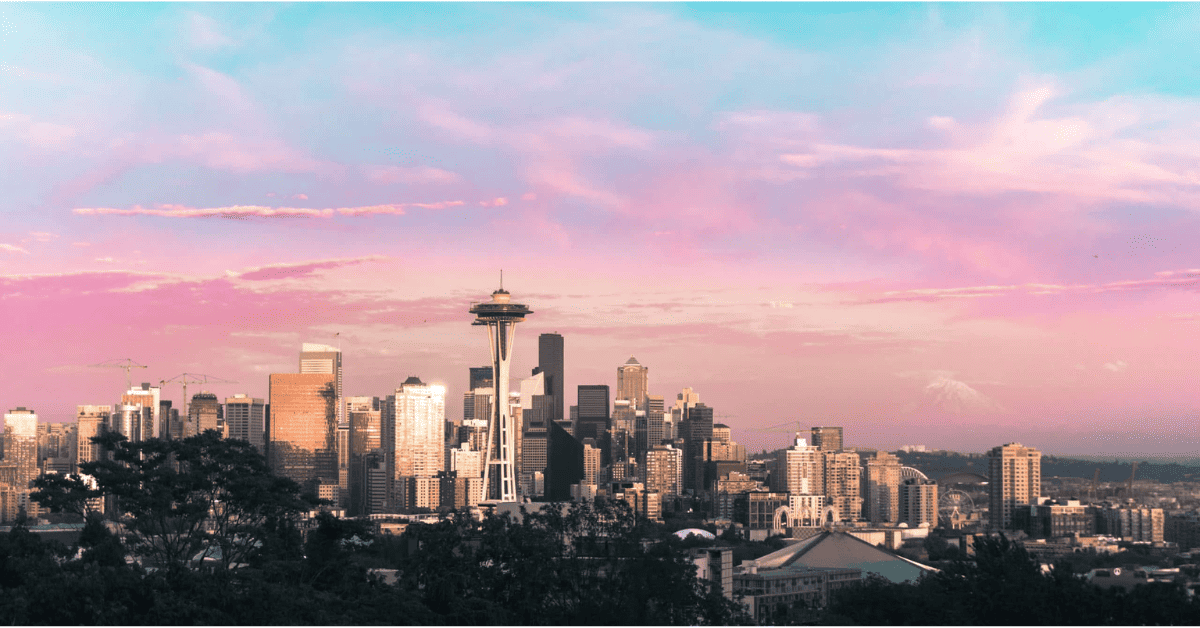 Seattle skyline at sunset with pink and purple clouds