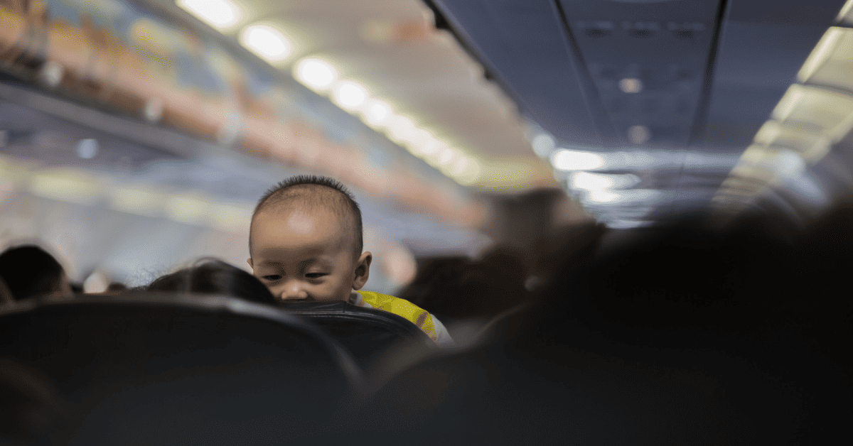 a baby looking over from the passenger seat.
