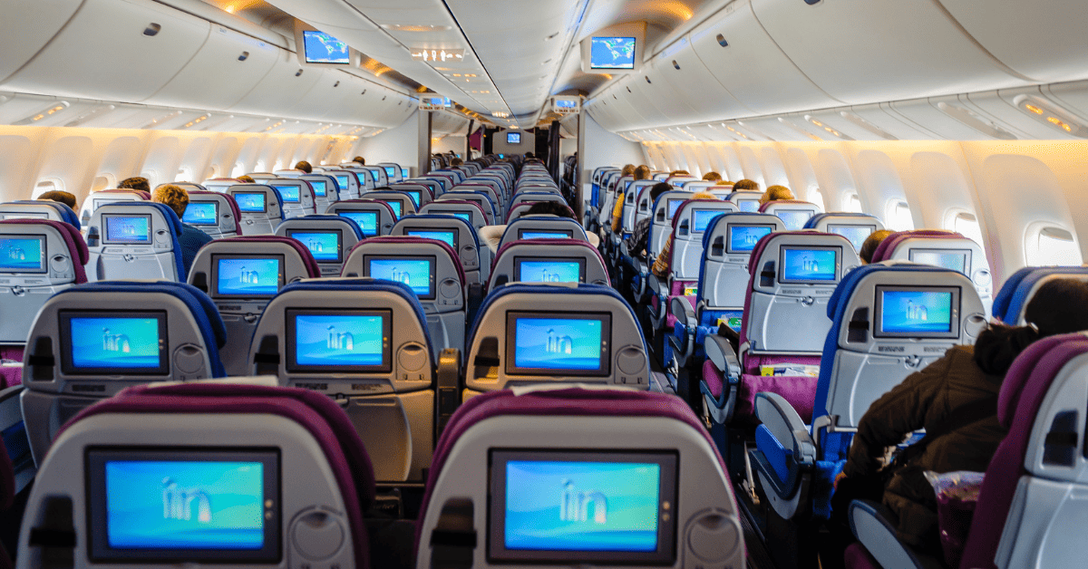 the interior of an airplane with a large number of monitors.
