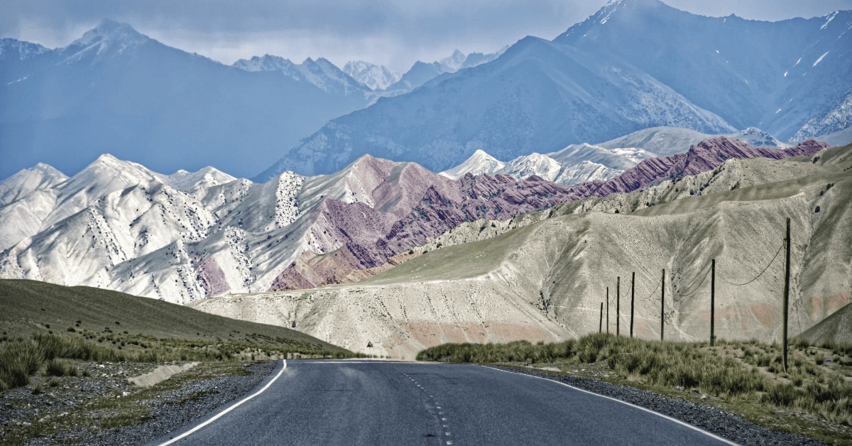 A road in the mountains with mountains in the background.
