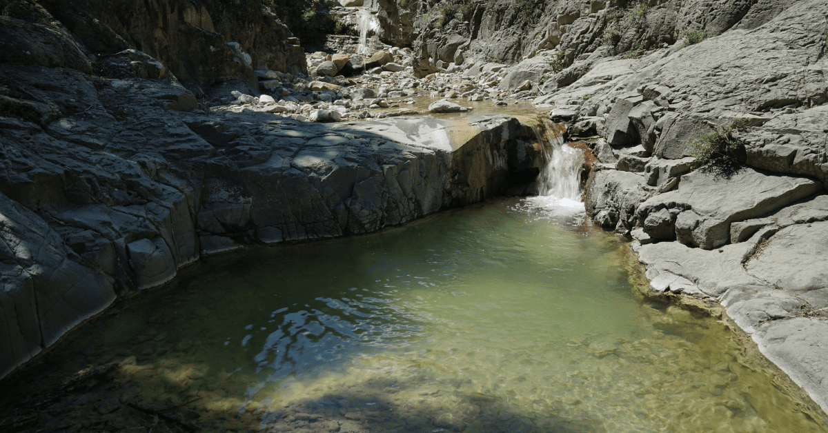 A small waterfall in the middle of a rocky area.