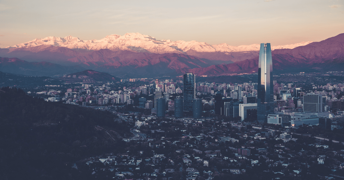 An aerial view of the city of santiago with mountains in the background.