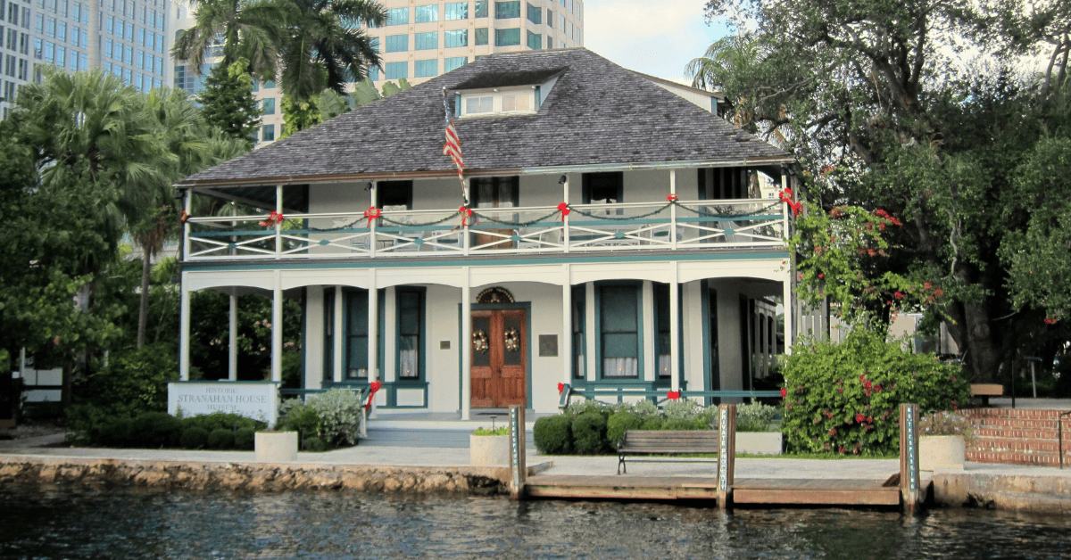 a house with a flag on the front with Stranahan House in the background
