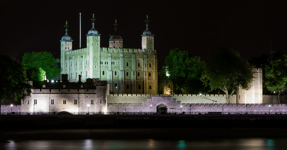a castle with lights on the side of it