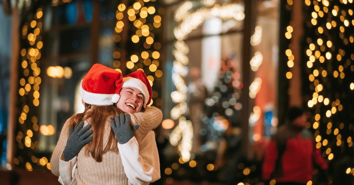 two women in Christmas costume hugging each other