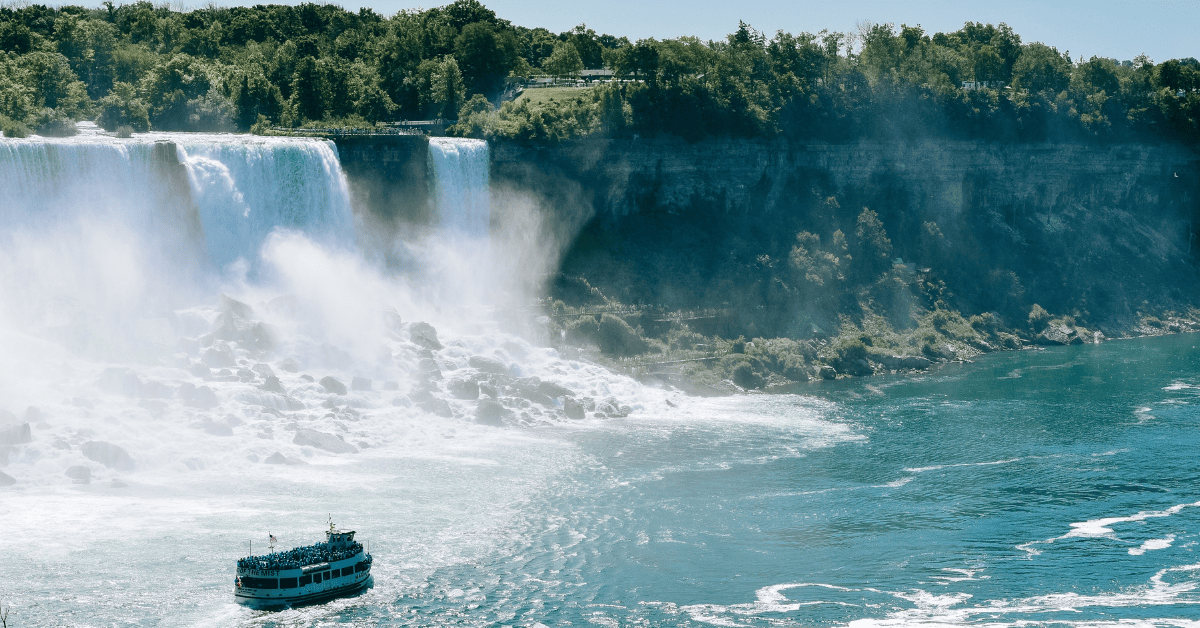 a boat in the water with a waterfall